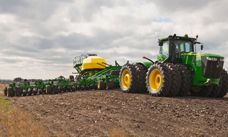 John Deere Planting Overcast Sky