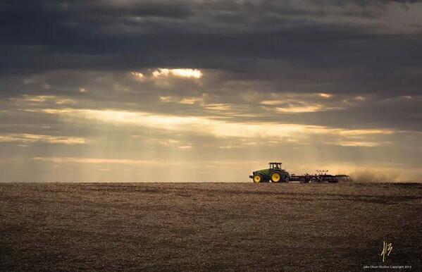 John Deere planter on field at dusk