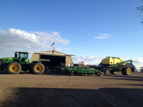 John Deere planter outside of garage